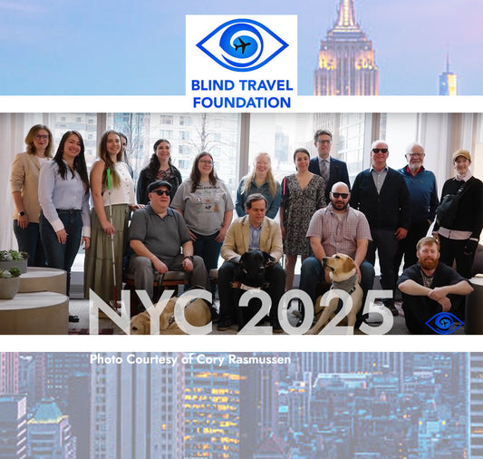 A group of 16 Adults posing in front of a large window overlooking new york city. Blind travel Foundation Eye and Airplane logo, NYC 2025 caption in bold letters