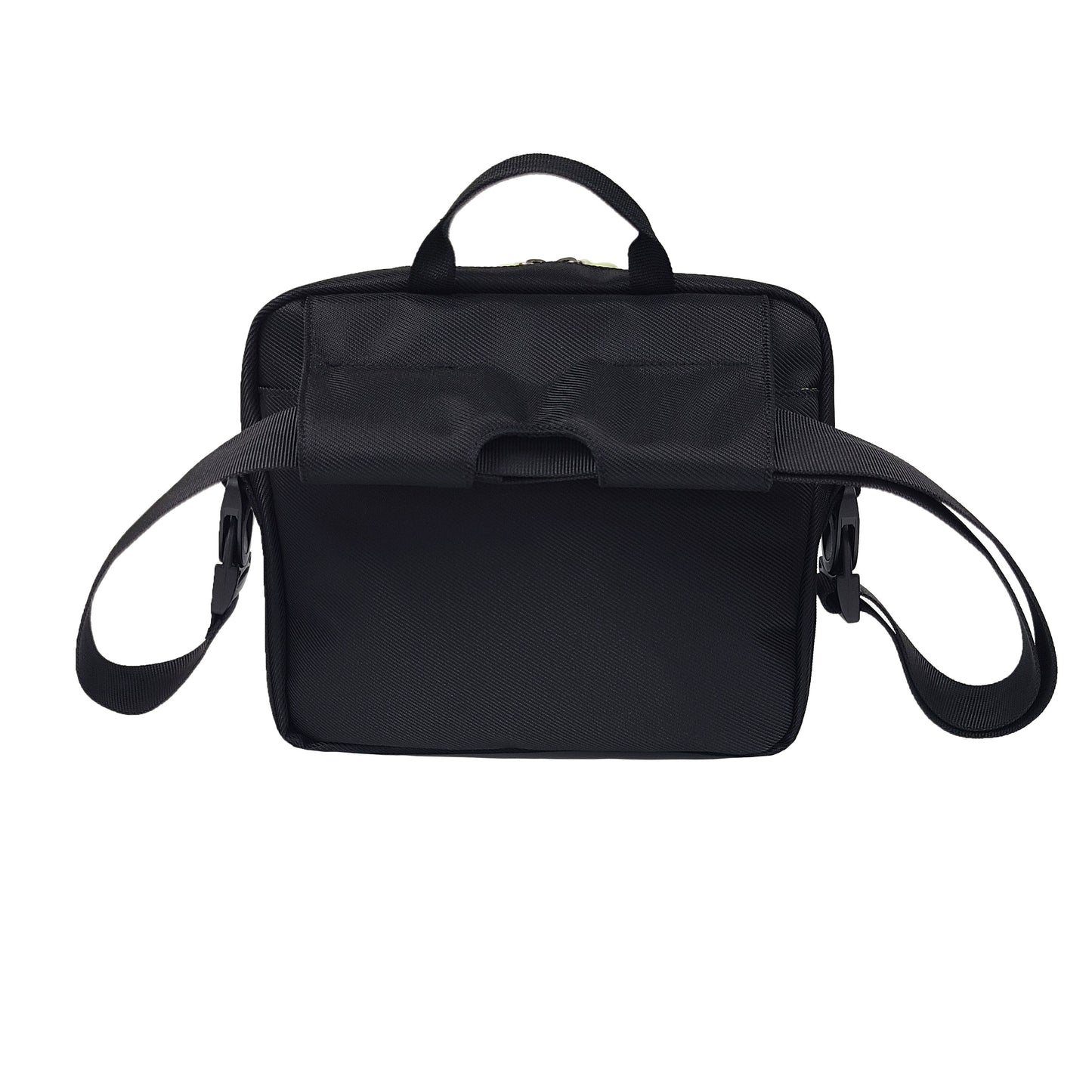 Back of a black satchel showing the single strap passing through the special flap that connects to the top of the bag, making the strap have two large loops on either side with which to connect to the handles or corners of a wheelchair back or a power wheelchair side arm.
