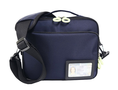 A square shaped travel pouch with a black shoulder strap. There is a transparent ID Case with a black frame attached to the lower front corner, removable velcro.
