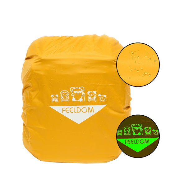 The bright yellow rain cover is stretched over the backpack. It shows rain drops are beading up on the water proof fabric. There is a glow in the dark design on the front, which is a lineup of 5 cartoon doggie characters, each using a different mobility device. They look badass, don't worry. Below them is a large white triangle with the FEELDOM logo inside.