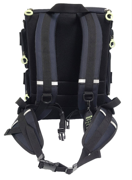 Back view of the CITY BLOCK backpack, showing contoured padded back and straps, adjustable chest strap, air mesh padded waist strap which is removable by clips. There is refelective tape along the edge of the straps and belt. A glow in the dark braille keychain is attached to one of the D rings