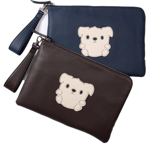 Two leather pouches, Navy blue and Chocolate brown, with wrist handles, have a white leather patch on the front in the shap of a dog character with a cute face.