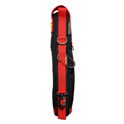 The back side of a black elongated pouch with a with prominent red webbing strap and loops along the whole side, a silver metal carabiner, D-ring, and black clip at the bottom.