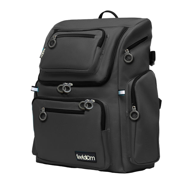 A black wheelchair bag with a contoured shape and several outer pockets with ring zipper pulls