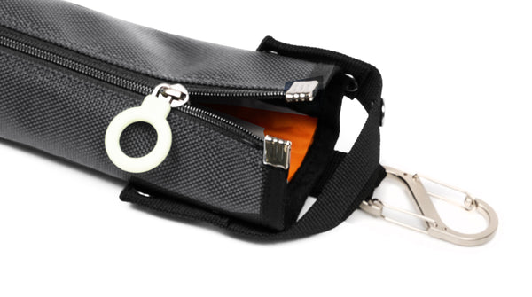 A dark gray cane pouch with an orange lining and white zipper ring
