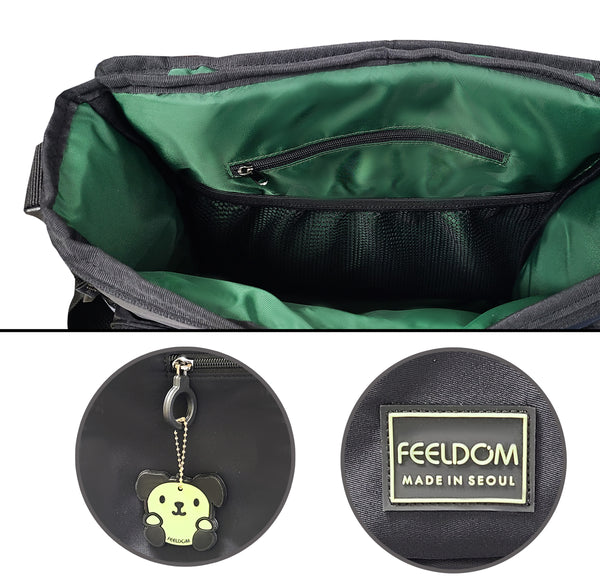 Close up details of the CHIC Z series Adaptable tote bag featuring a dark green shiny fabric lining, a glow in the dark doggie character rubber keychain, and a high visibility Feeldom logo tag on the bottom corner. Inside the main compartment is another mesh pouch for a divider.