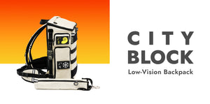 CITY BLOCK Low vision backpack, on white background with an orange sunset gradient. Side view of the Arctic White backpack with black trim and a cane pouch.
