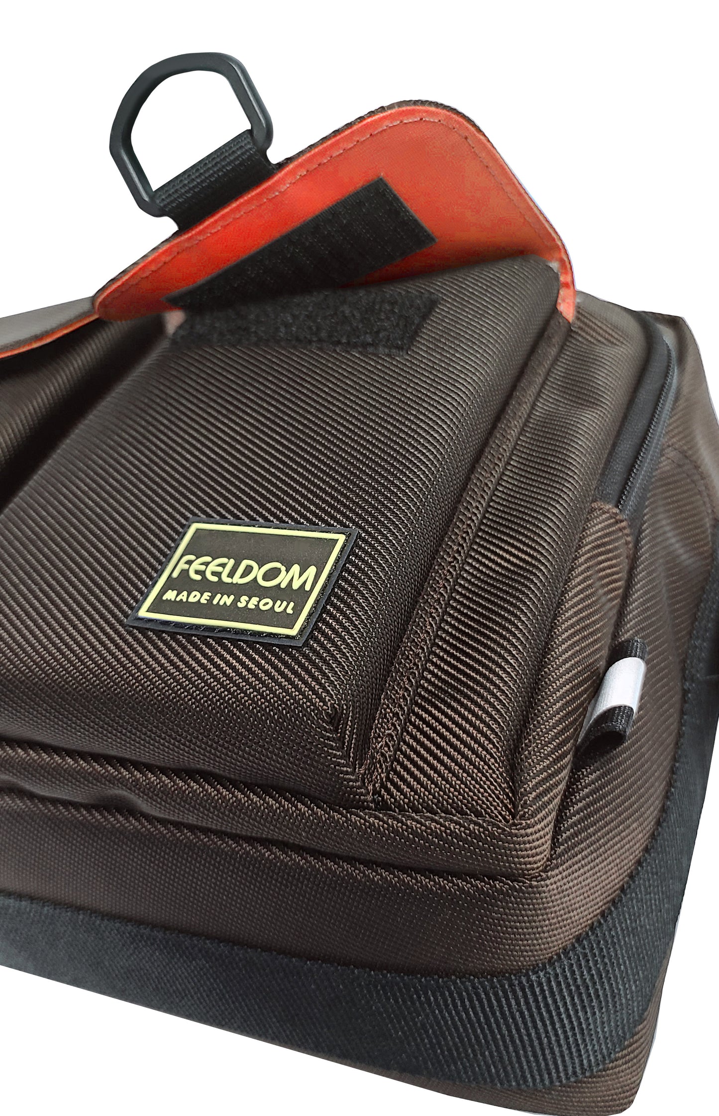 Pocket detail of the Dark Chocolate brown bag with the watermelon red lining inside and under the pocket flap.