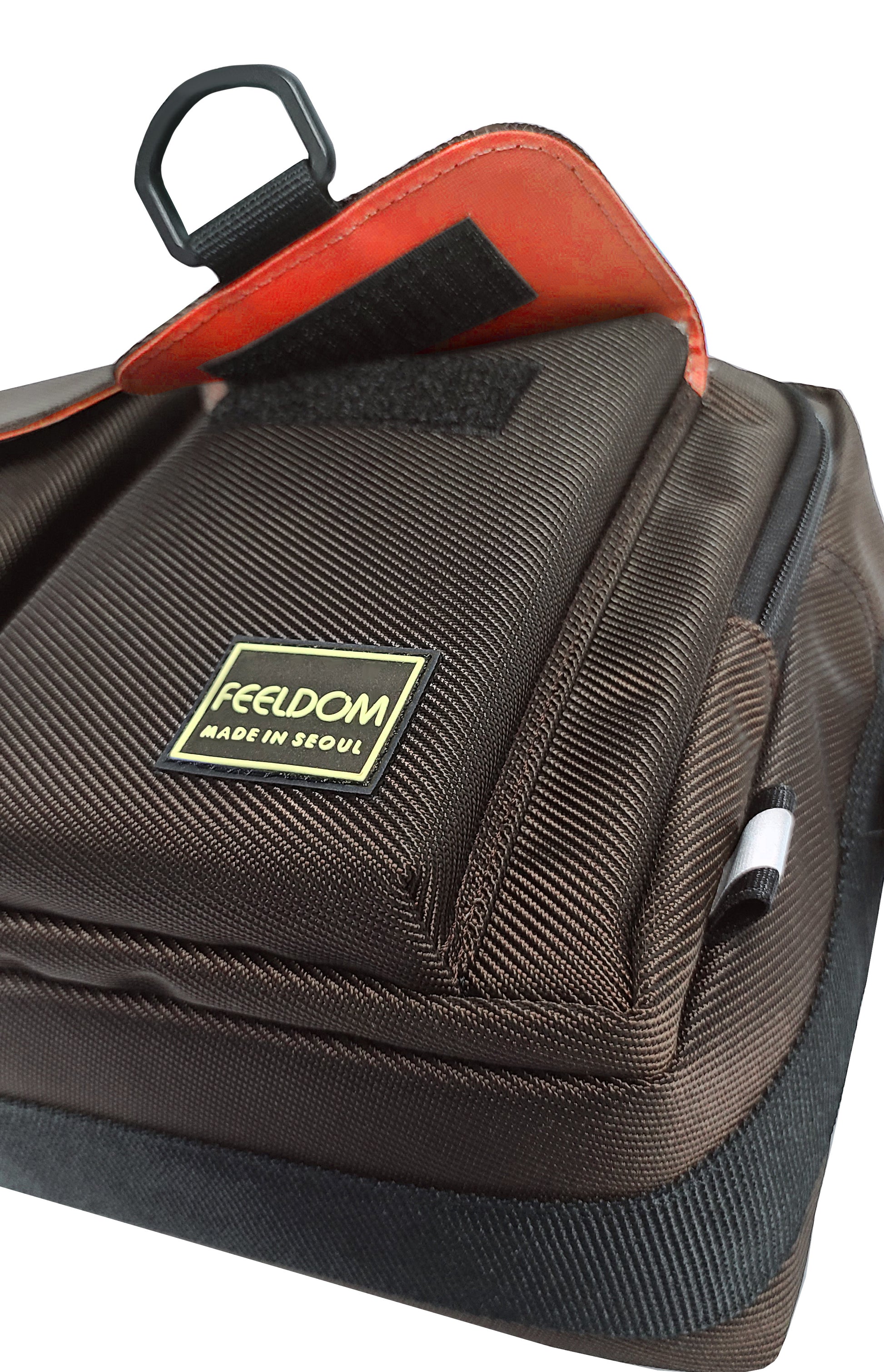 Pocket detail of the Dark Chocolate brown bag with the watermelon red lining inside and under the pocket flap.