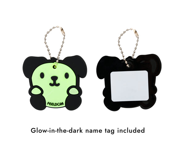Detail of the glow in the dark dog character keychain that is included with every CHIC LT24 bag. It has a cute face and black ears and feet.  The back has a white area that can be used for personal info.
