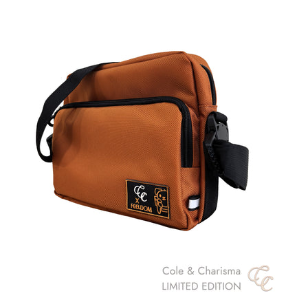 Front angled view of a Brown bag with black strap and visible brand logo. 'Cole & Charisma' LIMITED EDITION