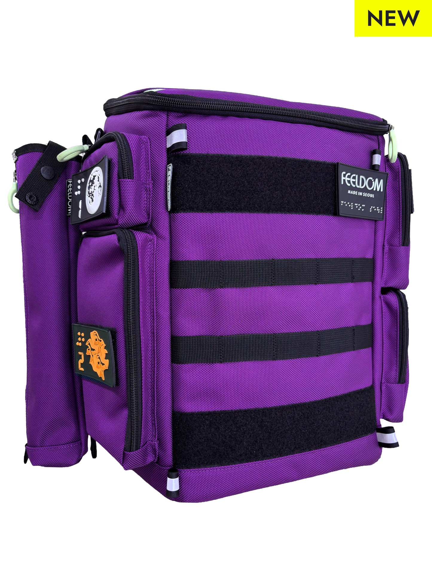 Purple backpack and cane pouch attached to the side. Backpack has black MOLLE webbing on the front and Braille design patches and FEELDOM Branding.