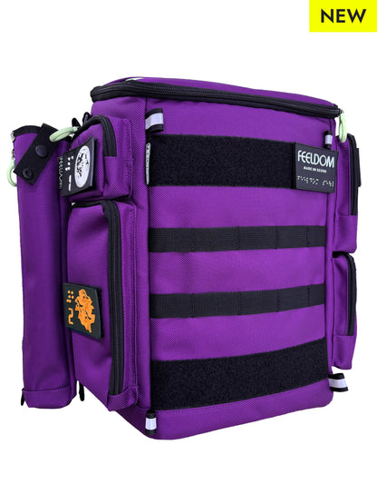 Purple backpack and cane pouch attached to the side. Backpack has black MOLLE webbing on the front and Braille design patches and FEELDOM Branding.