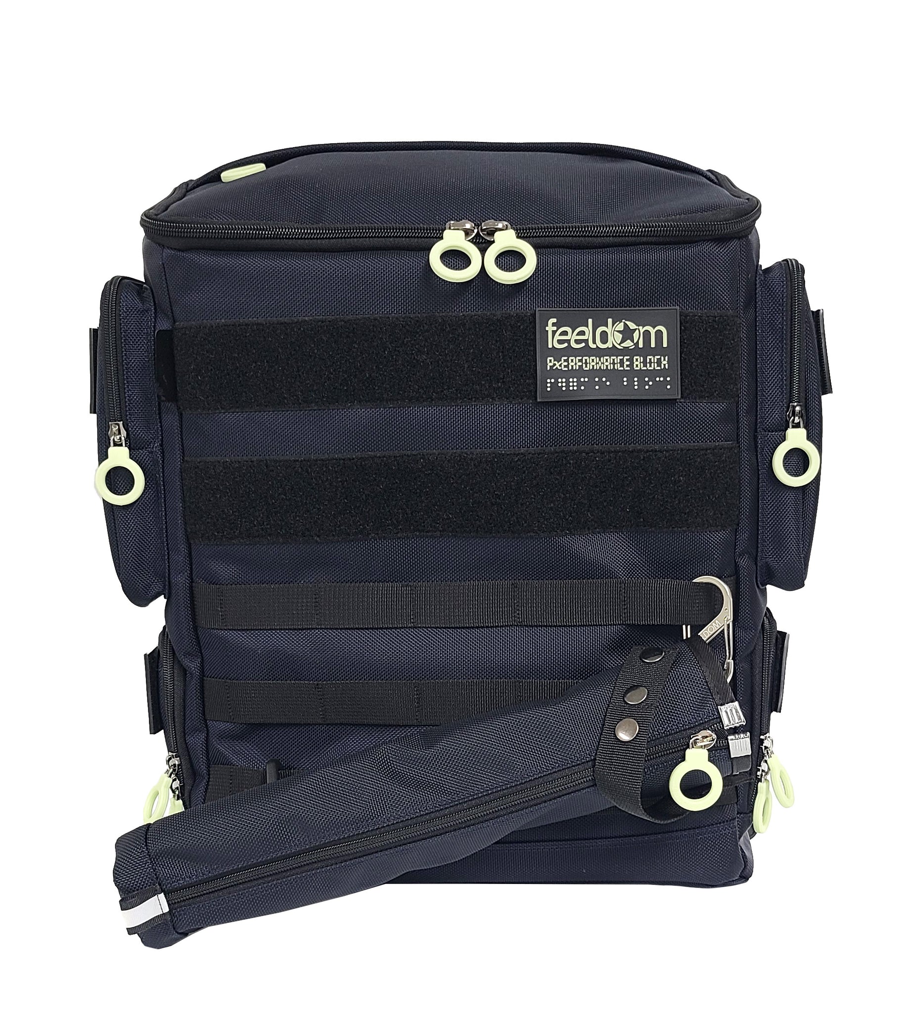 Front view of the Performance Block Medium S-Series featuring the new Cane pouch with a zipper and a metal carabiner attached to the front of the backpack. It has the matching color of the bag and a white zipper ring.