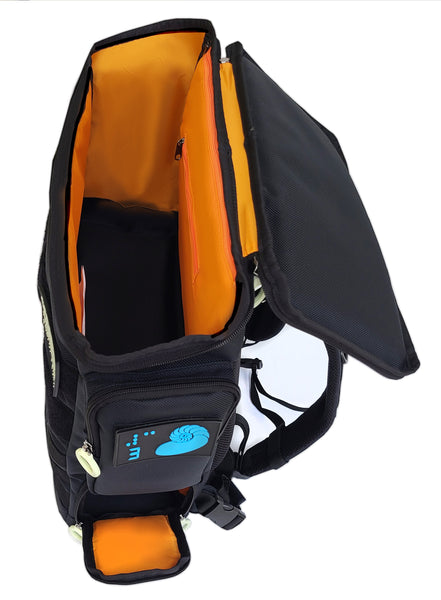 Side view looking in from the top of the Performance Block Medium HD-23 backpack. There is a bright orange lining on all the inside parts, and the bottom side access door is flipped open like a draw bridge. The zipper rings are white and there is a blue braille design patch on the side pocket indicating the number 3 with a design