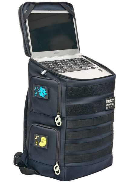 The Performance Block HD-23 backpack is standing upright like a rectangular tower. The top lid is open to show an open 13-inch laptop computer. The laptop deck has elastic straps to hold the screen of your computer securely. The bag can be used as a base for quickly opening your laptop and using it anywhere, even without a table nearby.