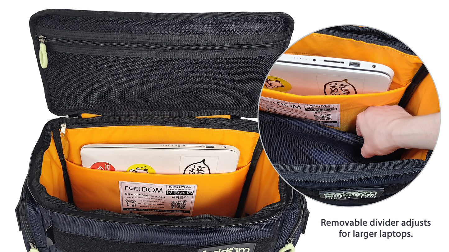 Close up detail of the padded laptop compartment in the Medium S-Series. It is a bright orange lining, and can hold up to 18.5 inch laptop. If the laptop is large or thick, the center divider can be released and curved or adjusted to allow the computer to fit comfortably in the compartment.