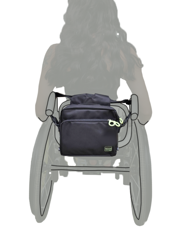 Black bag attached to back of a wheelchair 