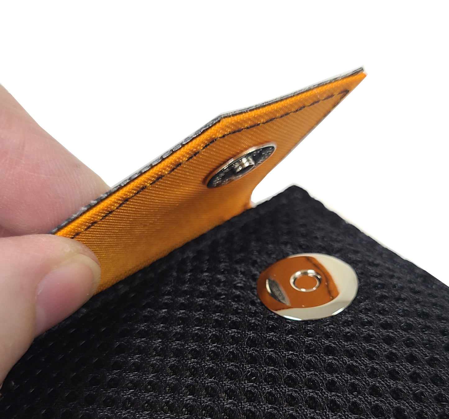 Close up detail of the magnetic snap that closes the case.  The flap goes over the top of the case and snap along the upper side of the back.