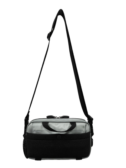 A small silver mini bag with a black pocket on the back. The black handle is also visible on the back.  The shoulder / crossbody strap is adjustable and made with a thick black nylon.