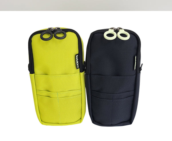 Side by side of a bright yellow-green and a dark navy QUIK-E Pouch. The navy one has white zipper rings, and the yellowish one has black zipper rings.