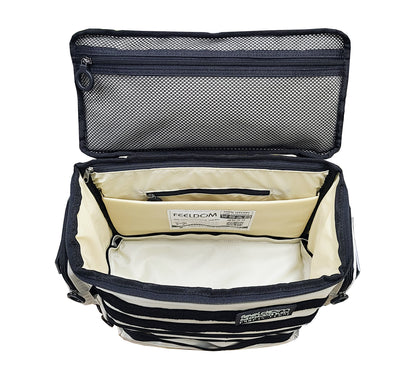 Inside top view of the Arctic White Performance Block bag, showing an ivory white lining and interior. The zipper pouch is black with a black zipper ring, and there is a large mesh zipper pouch on the inside of the lid. There is a padded laptop compartment along the back side and it has a velcro divider across the center of the inner compartment which is also ivory white.