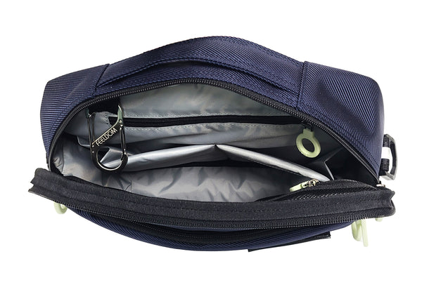 A Navy Blue Pouch with a handle on the top. Open, showing a silver lining and two padded pockets. On both sides are a zipper pouch with a white zipper ring.