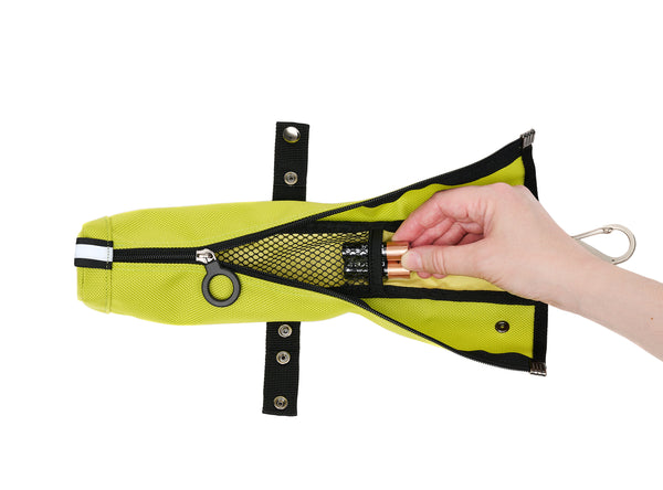 A bright yellowish green (called electric kiwi) cane pouch with black trim. It's zipped open to show a slim inner mesh pouch with 2 AA batteries being taken out. There is a metal S-shaped carabiner at the top, and the black snap strap is moved from the top of the pouch to the middle of the pouch, where it can be used to secure shorter canes or keep the zipper from going down all the way.