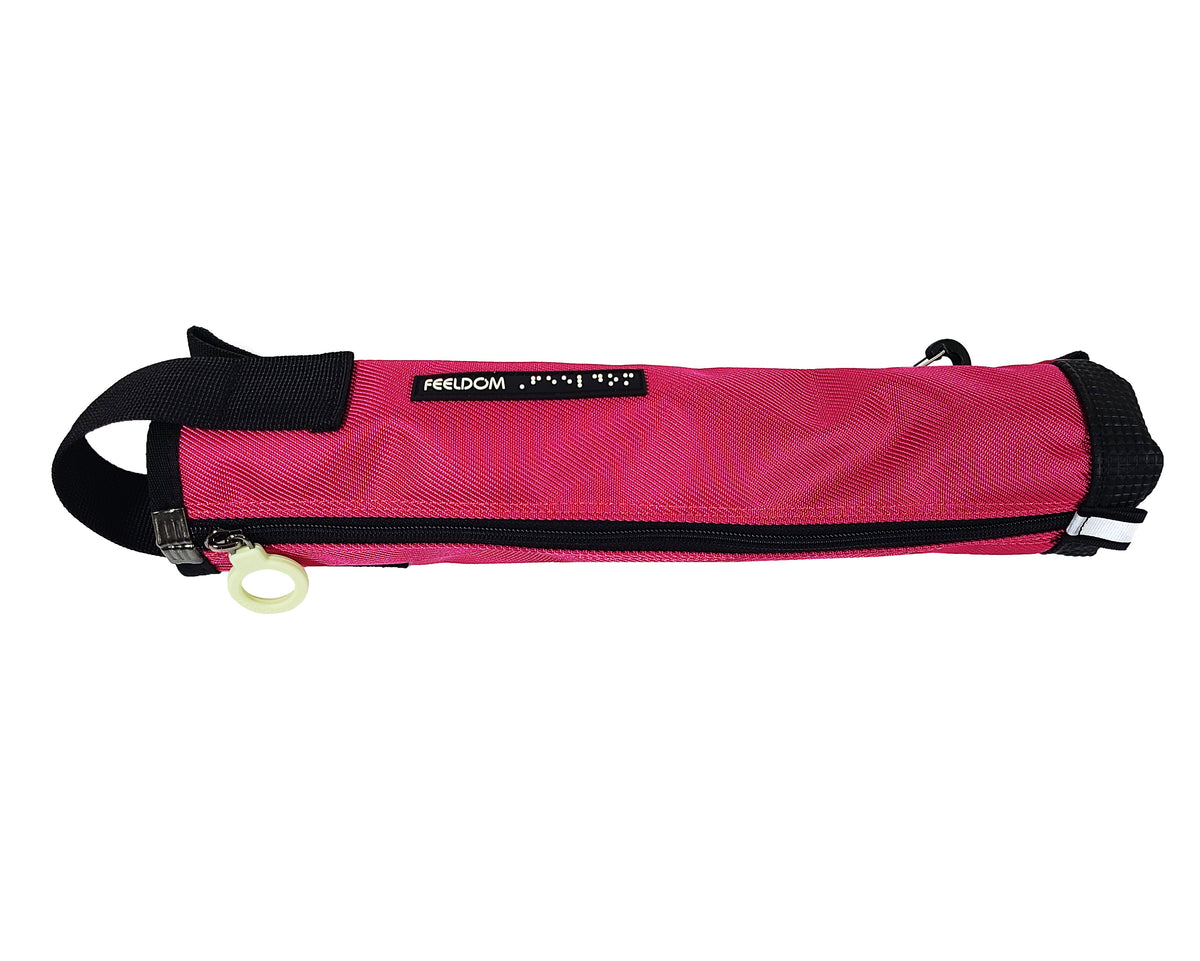 A hot pink cane pouch zipped closed with a black strap over the top and a small black and white braille FEELDOM logo tag and a black rubber base. The ring pull is white.