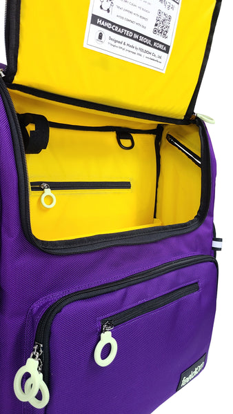 A dark purple wheechair bag opened up on the front with a yellow lining and another zipper and laptop pouch inside