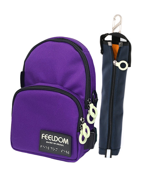 A dark purple (Twilight colorway) Jayu Crossbody bag and a navy blue Cane Pouch