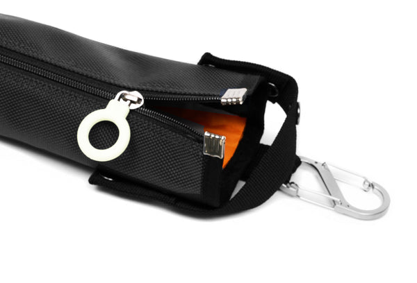 A black cane pouch with an orange lining and white zipper ring
