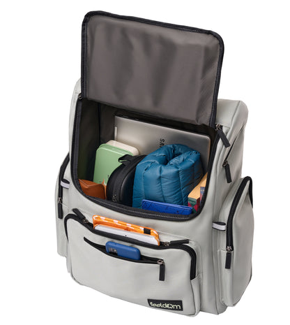 A large sturdy backpack that opens front-opening that unzips with a flip-up top. It has 6 outer zipper pockets and is filled with a jacket, books, phone, tablet, headphones, glasses, case and laptop computer.