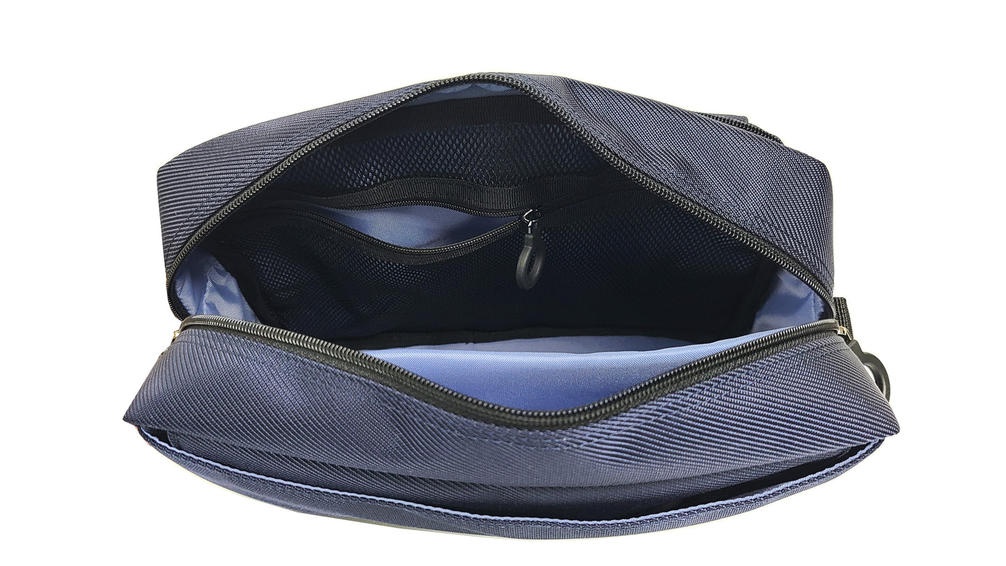 Top view of the inside of the adaptive bag showing a bright sky blue lining and black mesh zipper pouch with a ring zipper. There is a padded pouch for electronic items such as phone, tablet or e-reader, braill reader, ipad.