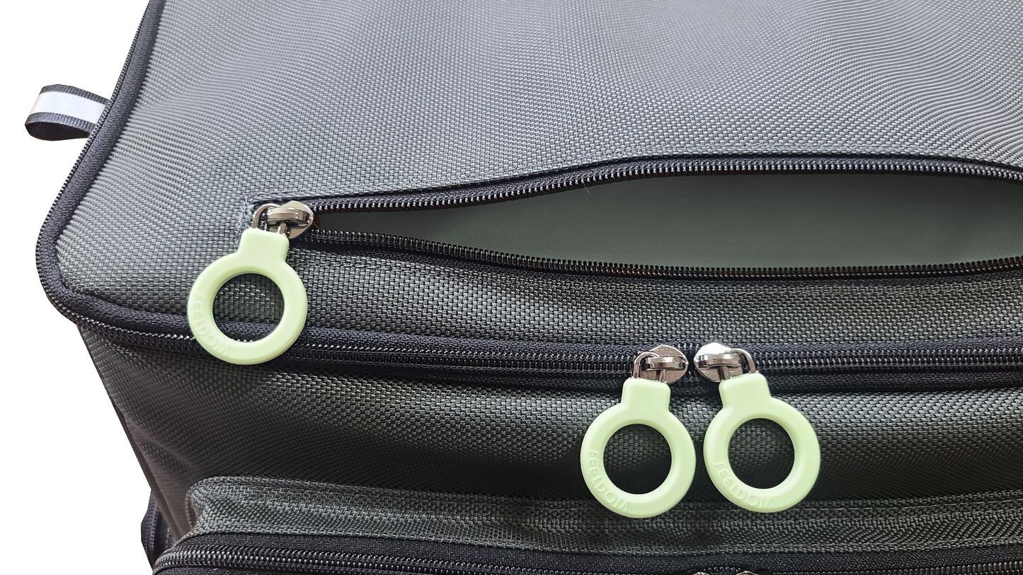 Close up of Feeldom TREK Backpack lid, with a horizontal zipper pouch on the top and a gray lining. The lid is a rectangular shape with double zippers.