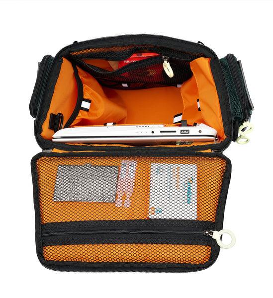 Top view of the City Block backpack with an open, trapezoid-shaped lid. The inside of the lid has a mesh zipper pouch with is large enough to hold medications, cords, small documents or other thin items. There is a 17 inch laptop in the widest pouch, and there are 2 pouches with flaps on the right, a large elastic pouch on the left, and 3 more mesh pouches on the inner front side. The top zipper pouch is open showing some snacks inside.