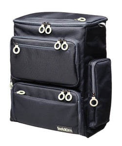A large box shaped Trek backpack in dark navy with large white zipper rings. There are 6 outer zipper pockets all with rings.