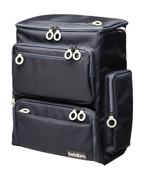 A large box shaped Trek backpack in dark navy with large white zipper rings. There are 6 outer zipper pockets all with rings.