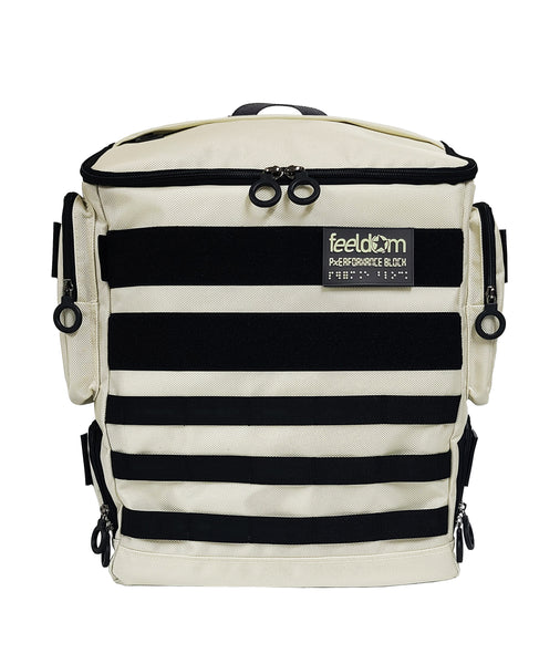 An arctic White Performance Block Medium S-Series has black trim and black webbing along the front. Both velcro strips are black with the FEELDOM Logo Braille patch on the front. It has black zipper ring pulls on the lid and the pockets.