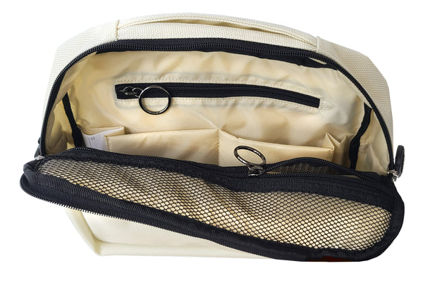 The Arctic White version of the TEKNO pouch is open to show it has an ivory lining and black trim inside. The zipper pockets have metal ring pulls, and the zippers are black, as is the mesh material of the pockets. It's a neat contrast.