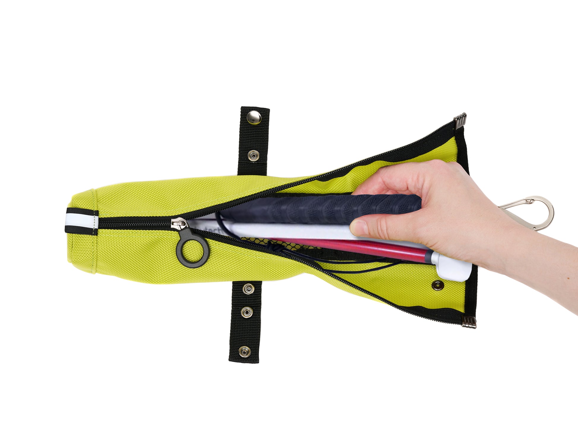 An unzipped cane pouch and a folded up cane inside. A hand is reaching in. The adjustable strap is unsnapped.