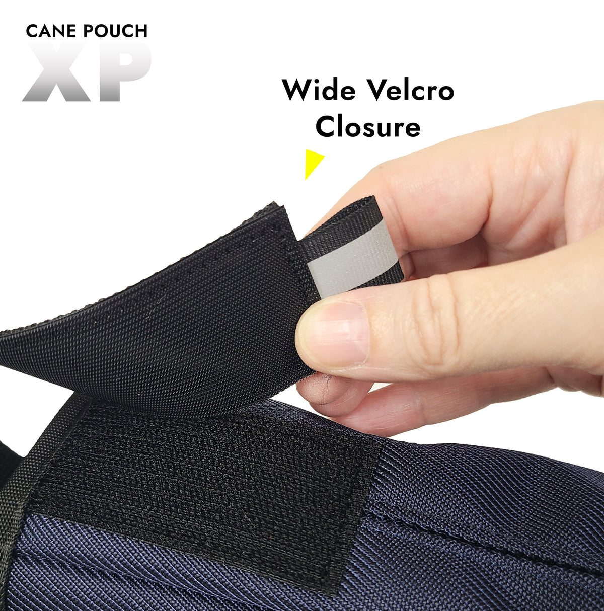 Close up of a velcro strap that closes over the top of a cane pouch. The strap has a reflective tab at the end.  The title says "Wide Velcro Closure, Cane Pouch XP "
