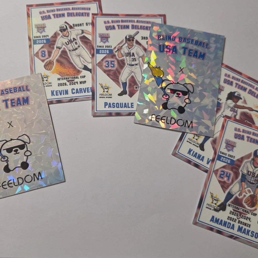 A collage of baseball cards with a shiny, holographic backing. Each card has a baseball player in a white and blue USA uniform with their name at the bottom and their jersey number on the left. The top says US Blind Baseball Association USA Team Delegate