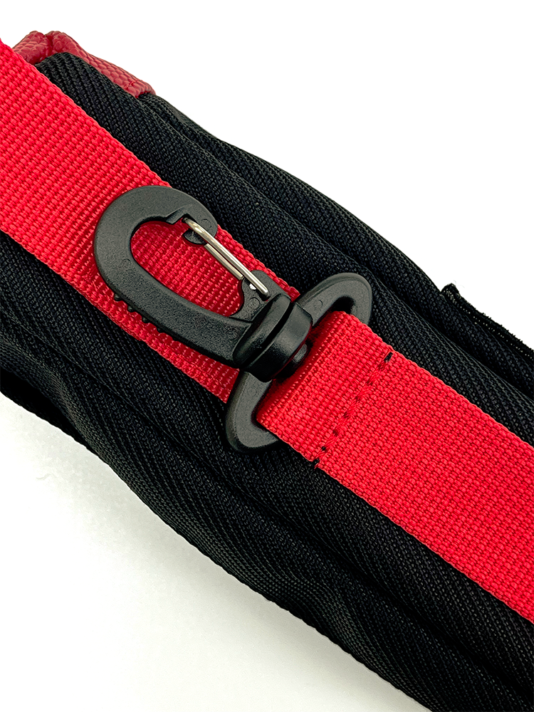 Close-up of a red webbing strap with a black plastic swiveling clip fixed to the back towards the bottom of the pouch.
