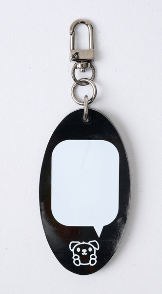 Reverse side of the Goldie mascot keyfob. There is a tiny Goldie at the bottom and the large space is an empty white speech bubble. This area was designed to write your contact info, name, emergency info, or to place braille ID stickers or labels on it easily.