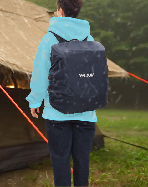a person outside their camping tent in the rain wearing the trek backpack with the rain cover  on it.  The rain is running off the backpack.