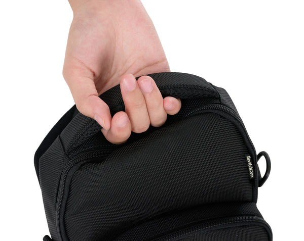 Close up of the hand holding on to the padded top handle of the crossbody bag. The handle is comfortable and contoured for a snug fit around the knuckles of your hand. There are D rings on both sides of the bag.