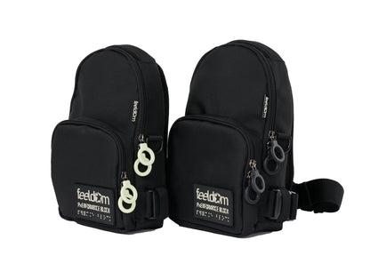Two black crossbody bags shaped like mini backpacks. They are both black. One has black ring zippers and the other has white ring zippers.