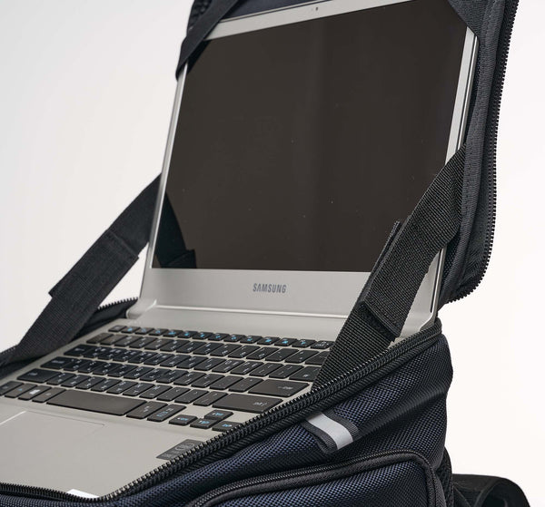 A laptop computer is neatly installed in the top "deck" of the performance block backpack. The square zip-open lid is held open by hinges of reinforced nylon straps with adjustable velcro. The corners of the open laptop screen are held in place by thick elastic straps along the edges. This particular computer is a 13 inch Samsung notebook computer in silver. Performance Block remains upright and rigid even while empty, so it is easy to use the computer "deck" like a portable desk. Anywhere you want!