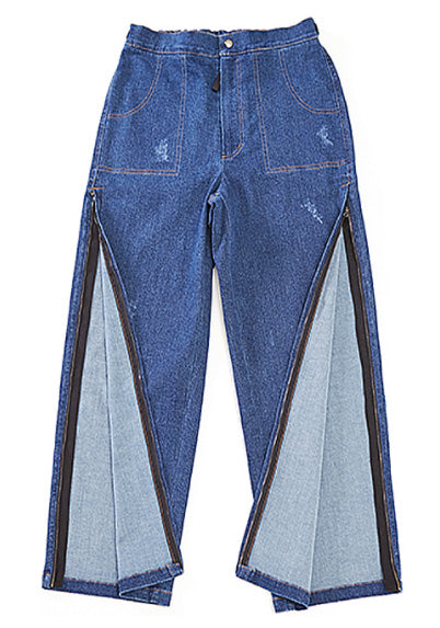 Full length view of Feeldom Real Jeans BraceX Model. The zippers on each leg go from upper thigh to the bottom of the Jeans for easy on /off of braces and other medical equipment. They are wide legged with plenty of room and flexibilty.  These jeans have detail sewn on pockets (not real pockets.) But surprise!! There are real pockets on the back of these.